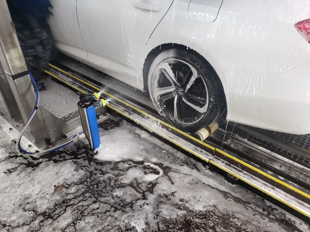 Close-up of wheel being cleaned during exterior wash